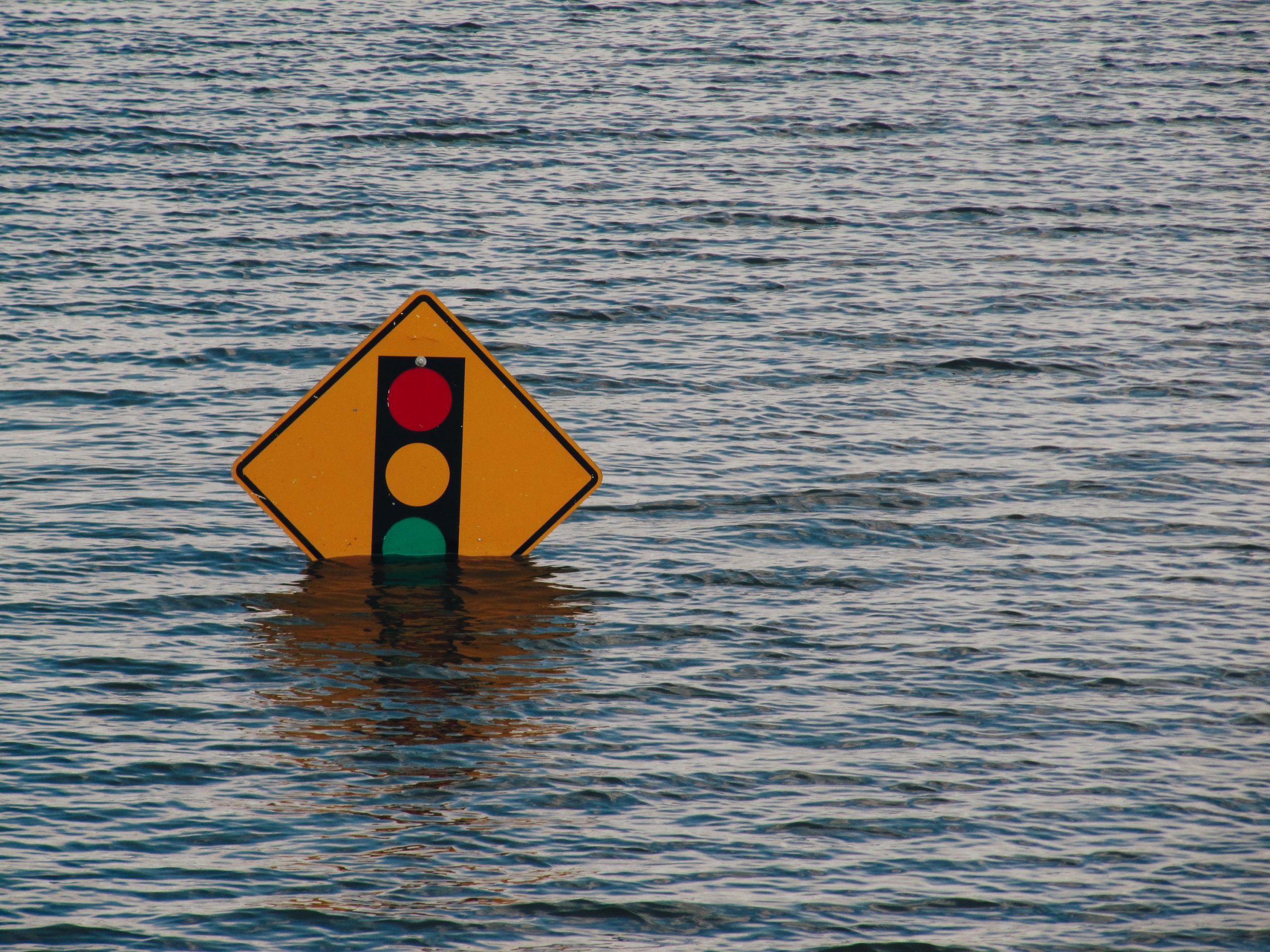 traffic light sign till green light under water, flooded street